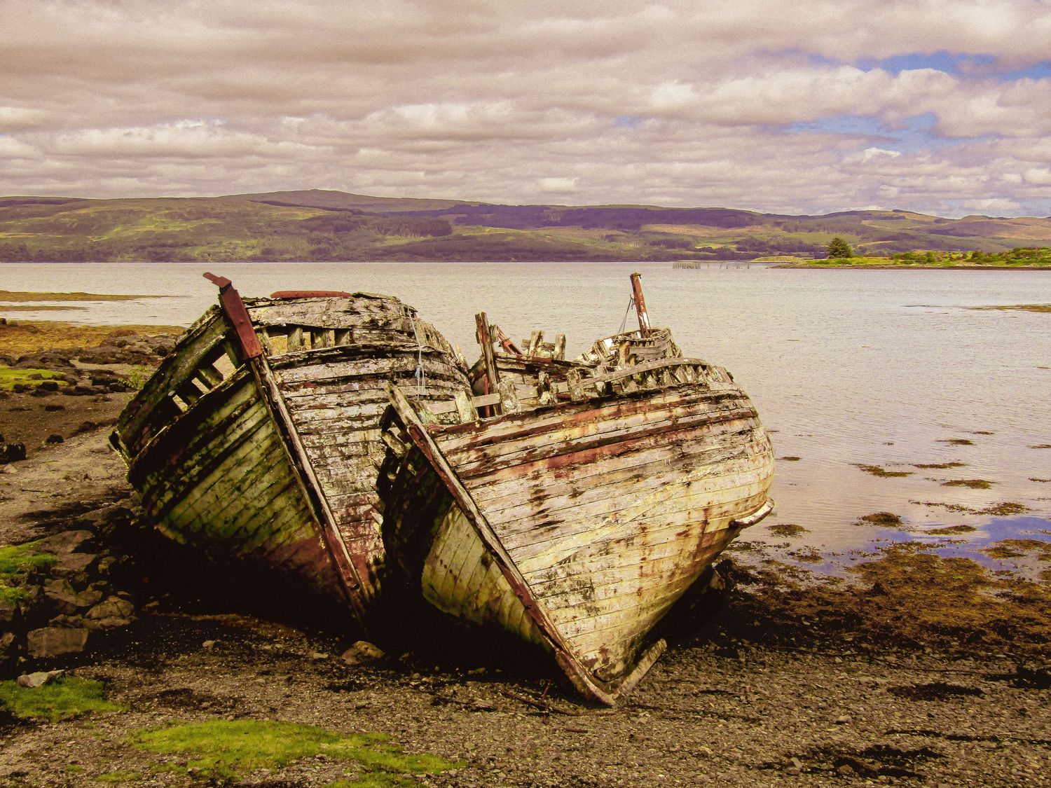 Fine art Isle of Mull two decaying shipwrecks resting on rocky shoreline Salen Bay Scotland, framed wall art prints and downloads.