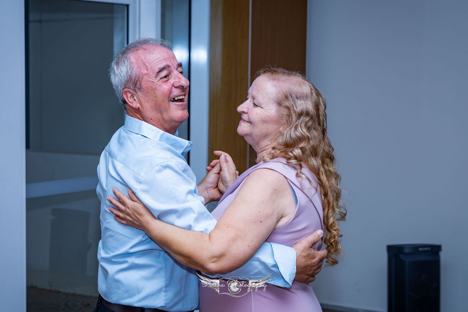 Older couple dancing together during wedding celebration.