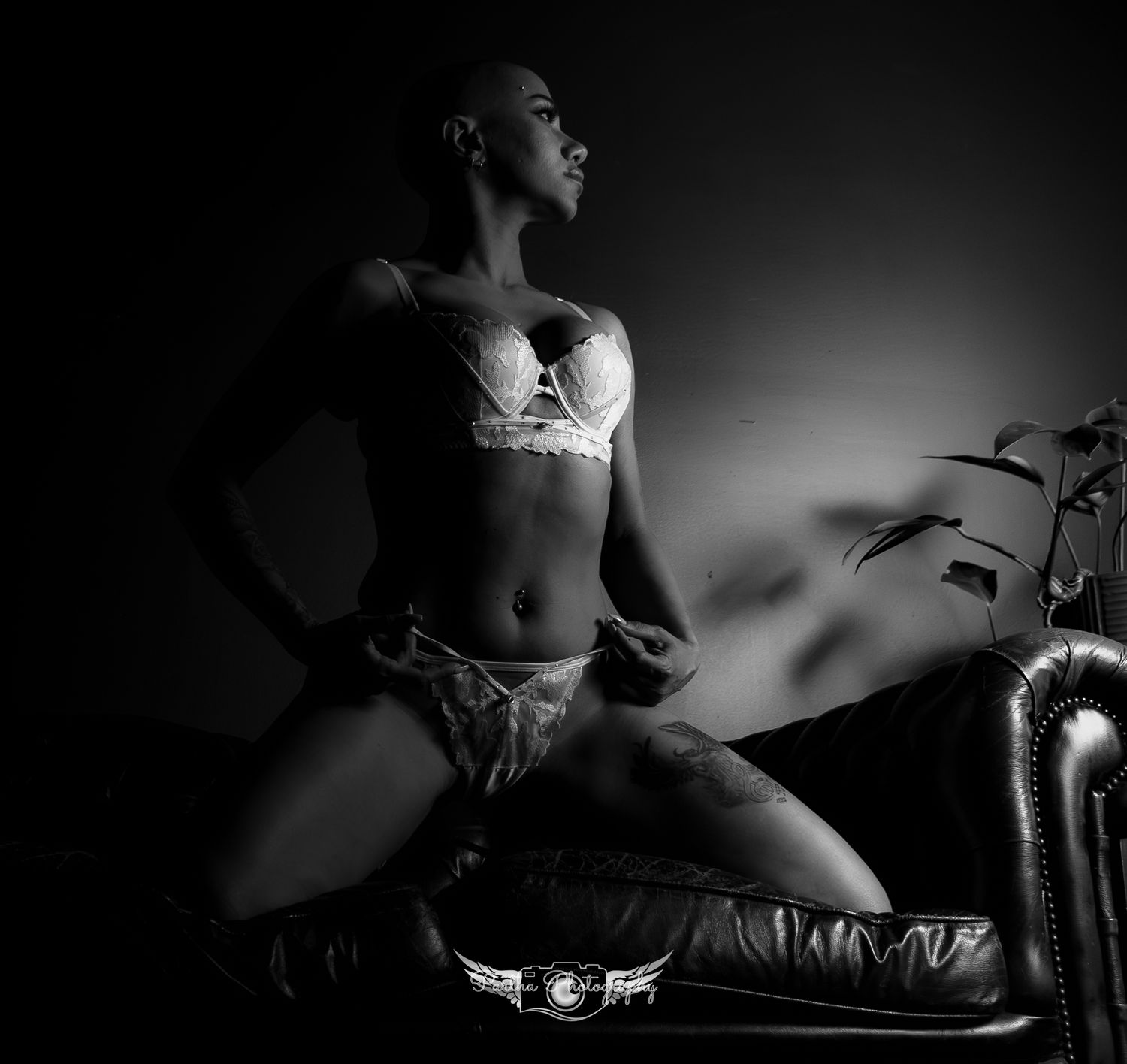 Black and white boudoir photography with dramatic shadows and lace details.