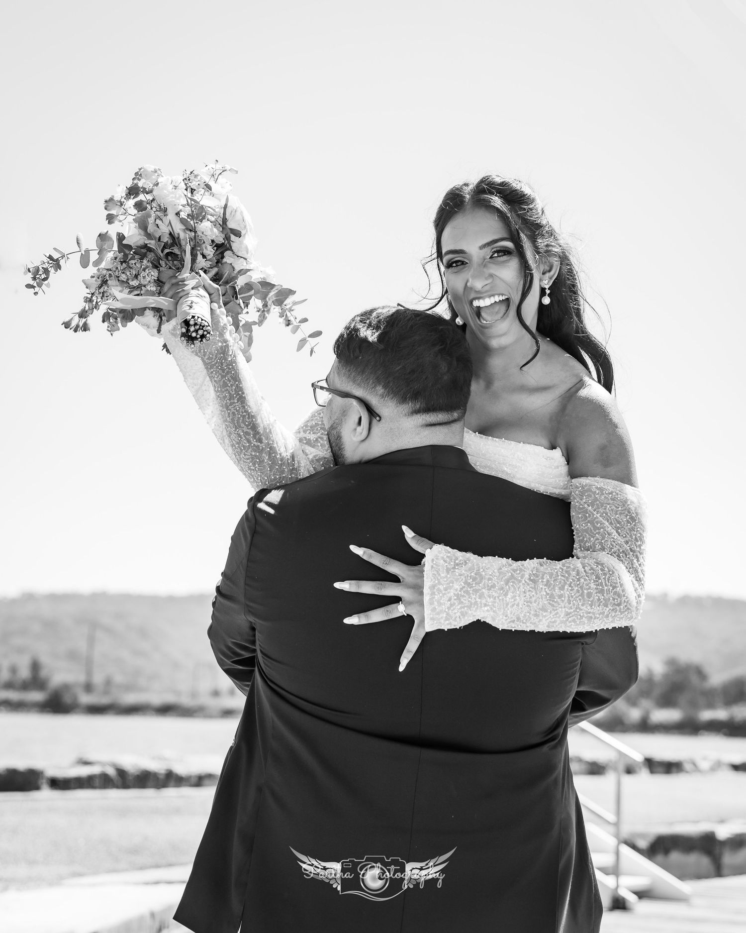 A black and white photo series showing intimate embraces between two people set against outdoor backgrounds.