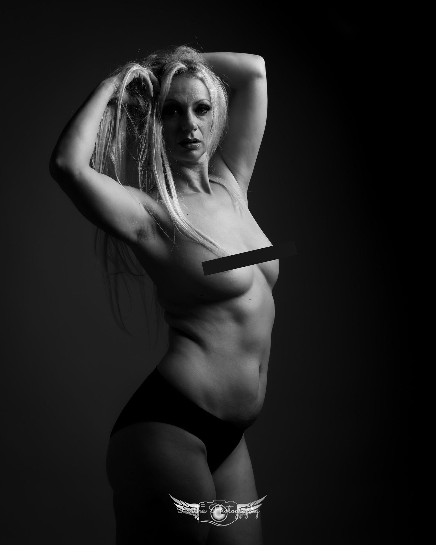 Black and white artistic portrait with minimalist lighting.