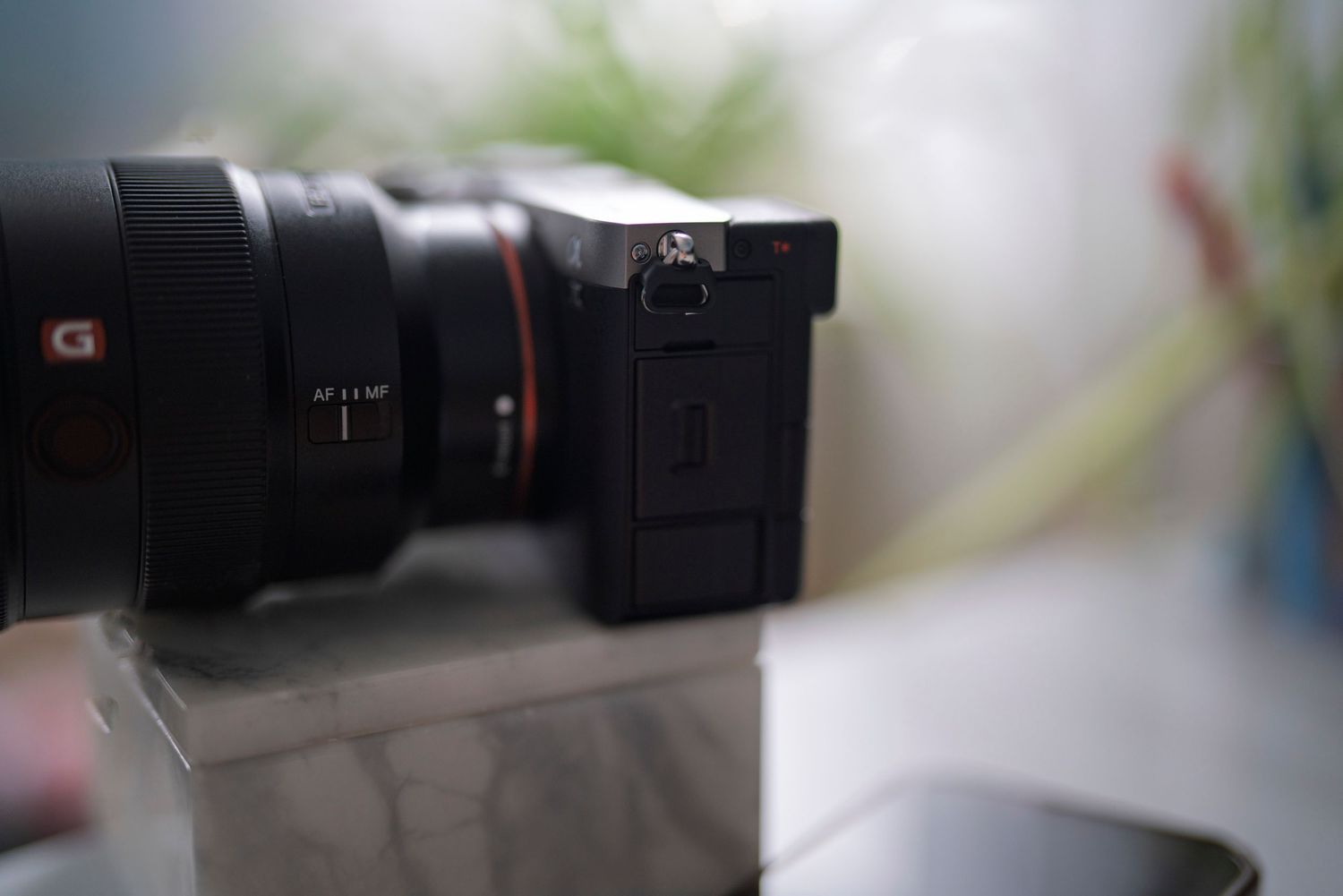 Close-up shot of a digital camera with lens on a blurred background.