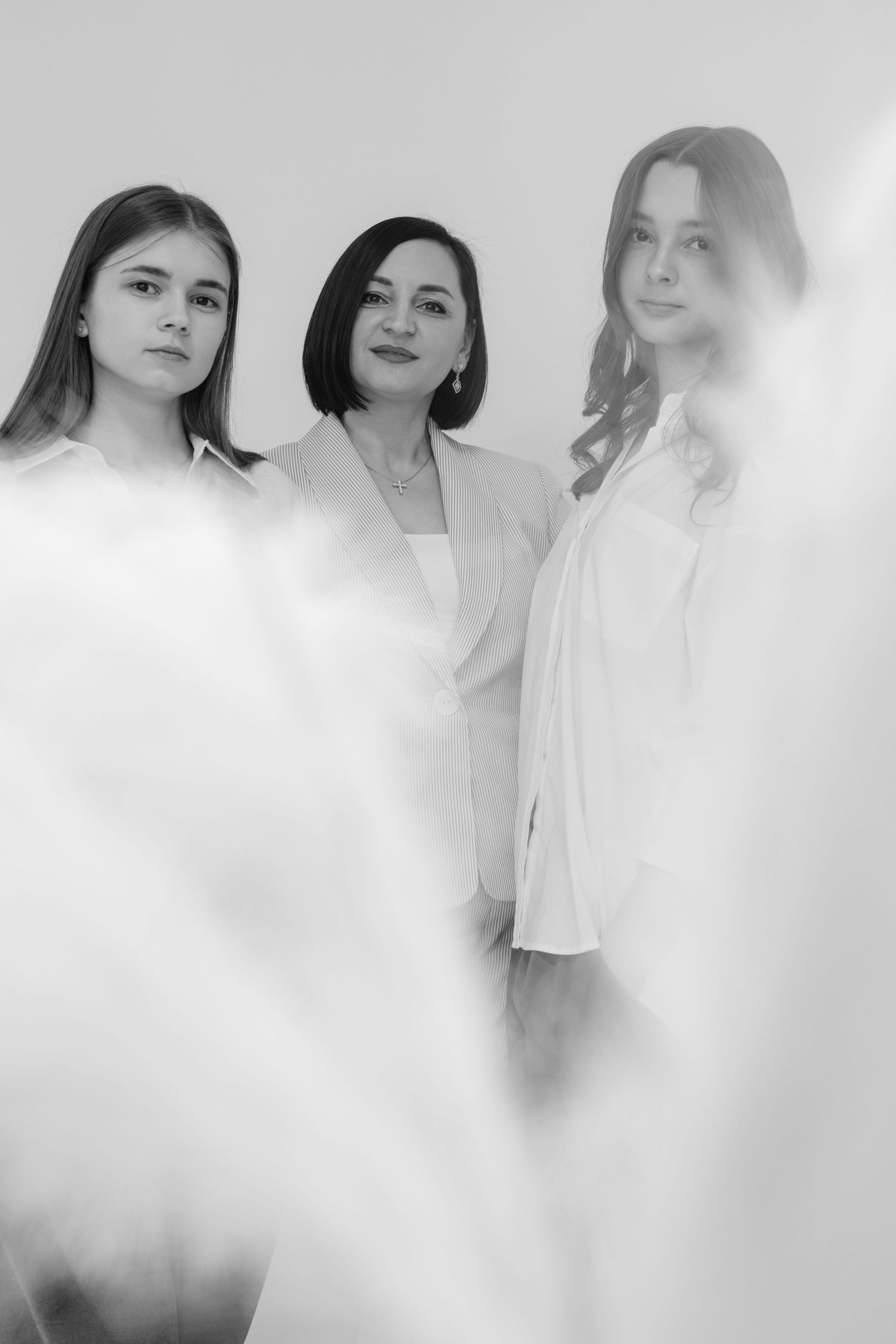Artistic portrait series with fog effects and white clothing against light background.