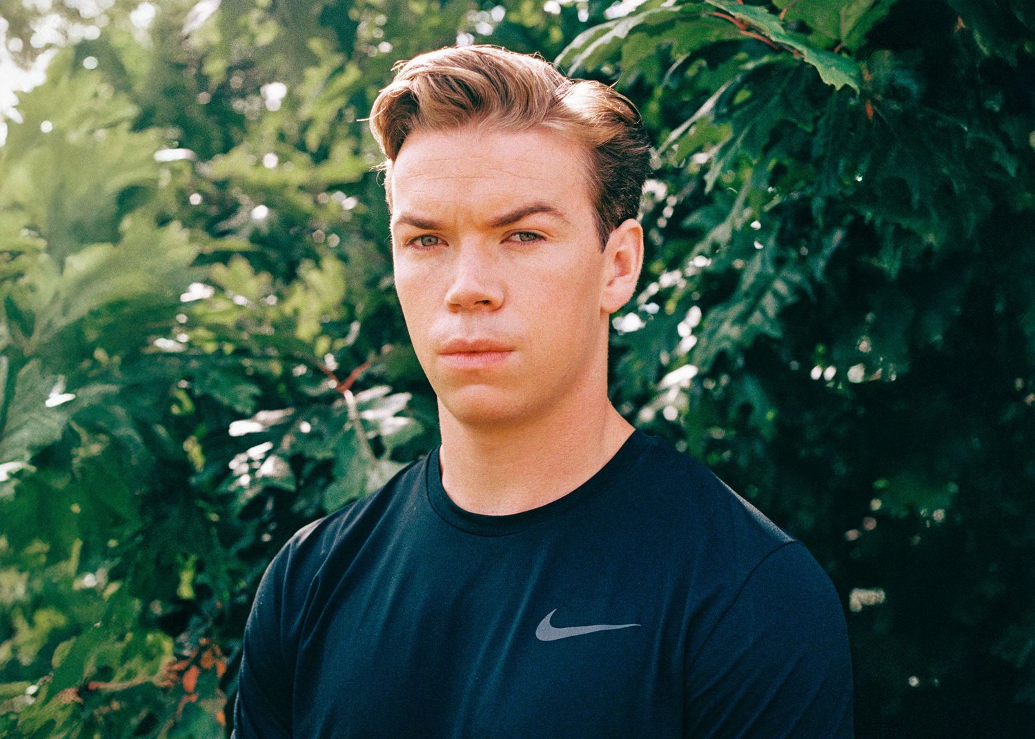 Portrait series against greenery showing different facial expressions.
