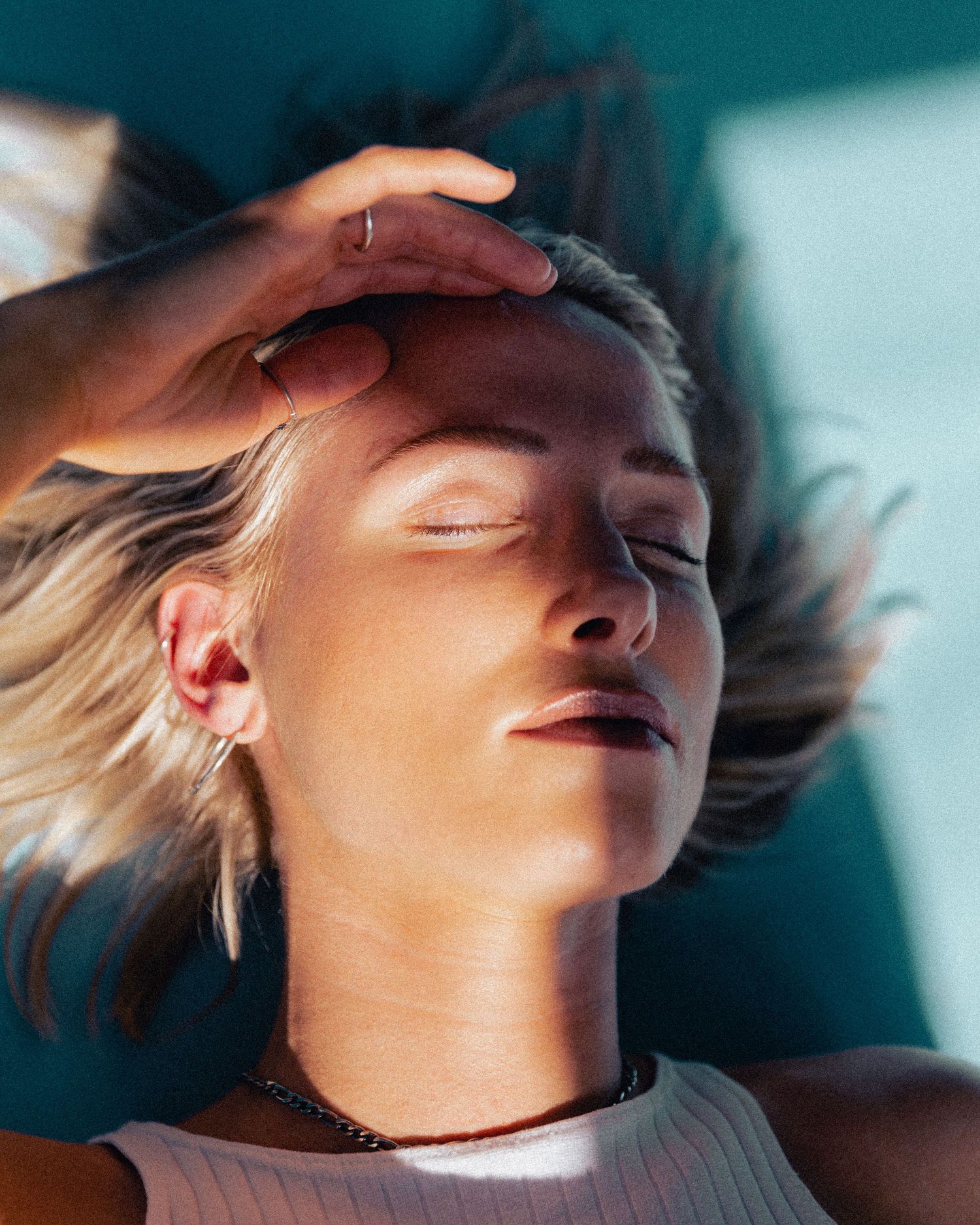 Artistic portrait sequence with dynamic movement and dramatic teal lighting.