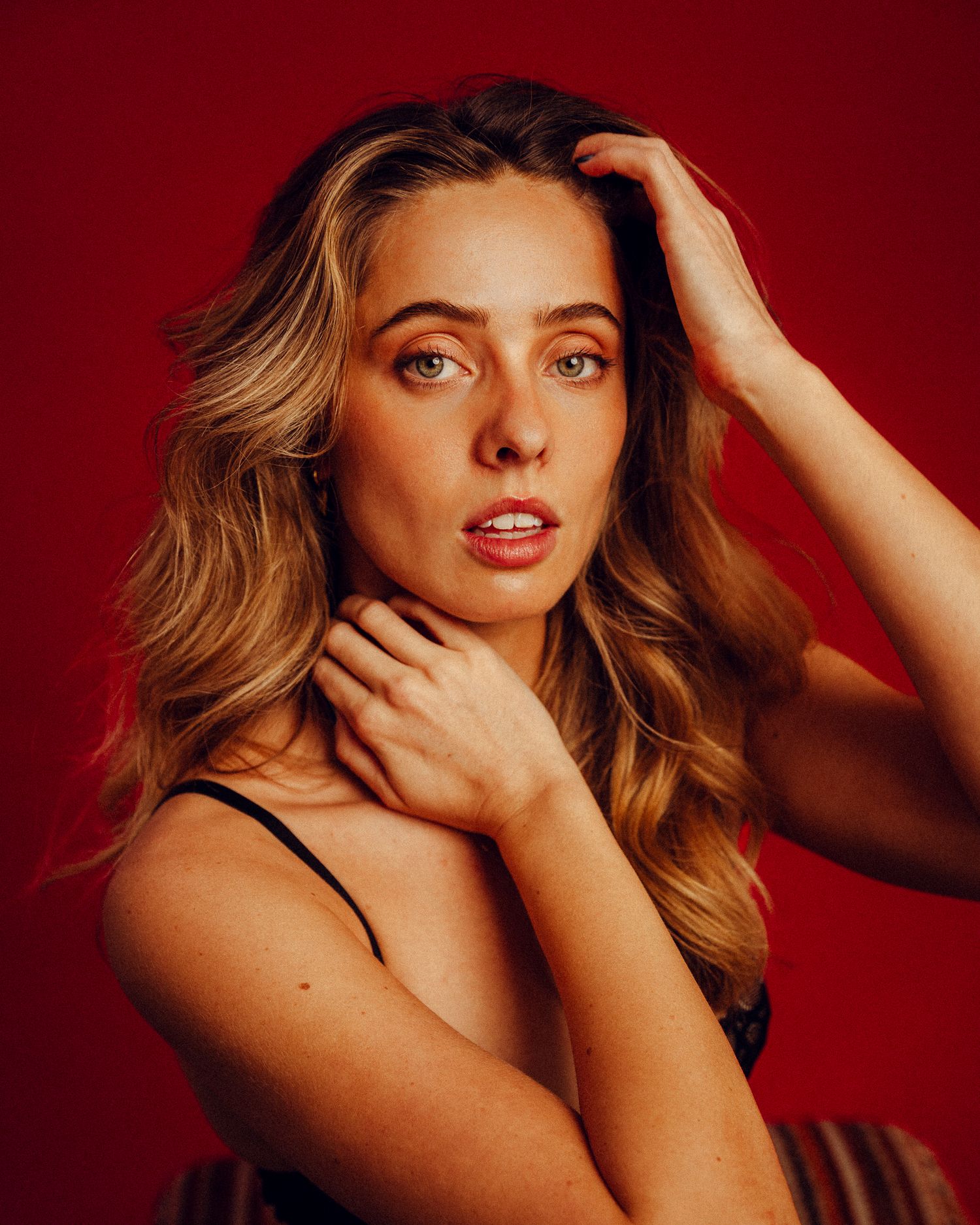 Dramatic portrait series showcases expressive poses in studio lighting.