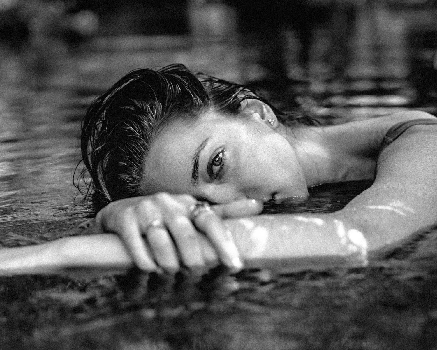 Artistic black and white photo series showing figure submerged in dark water.