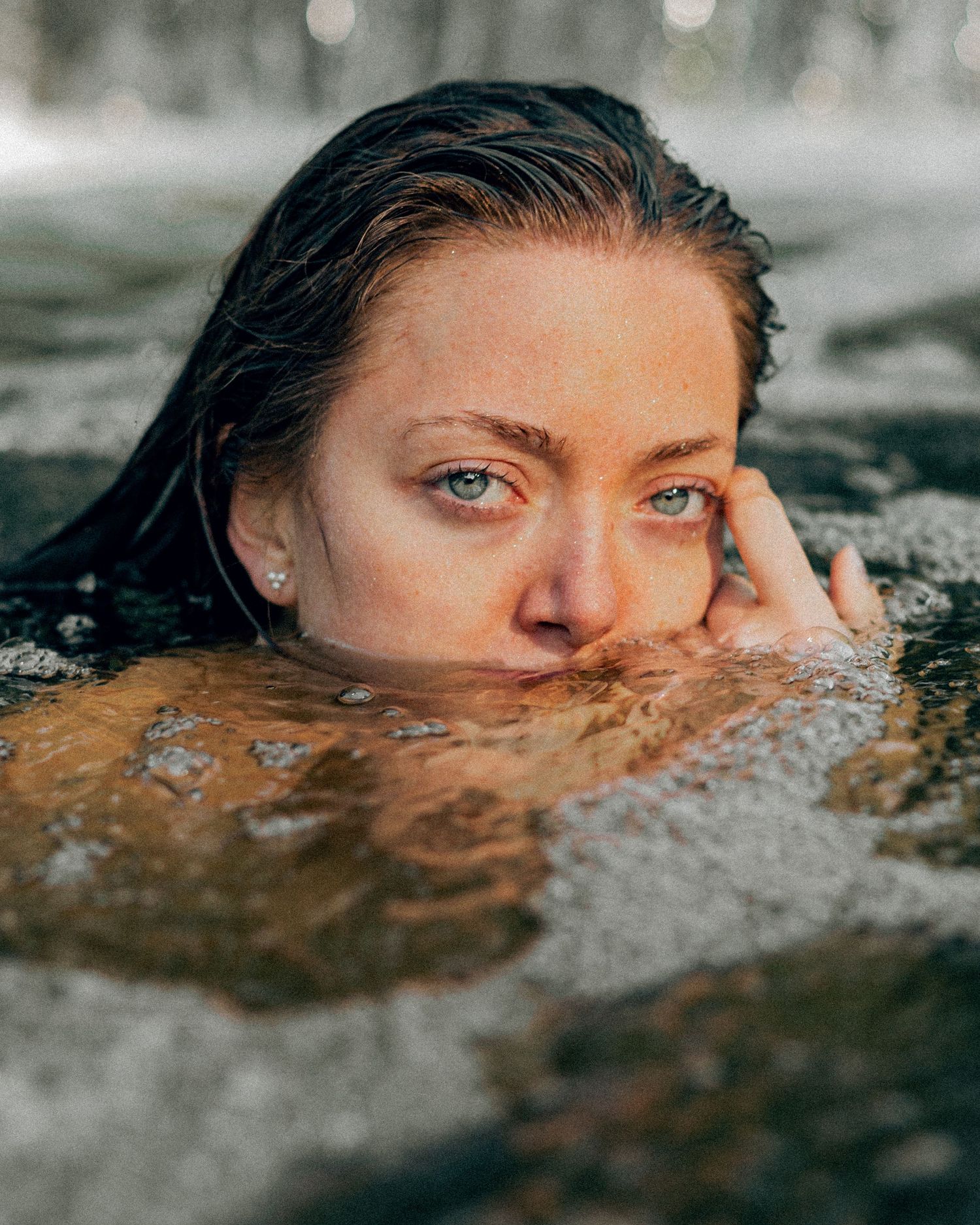 Close up water portrait showing partially submerged face.