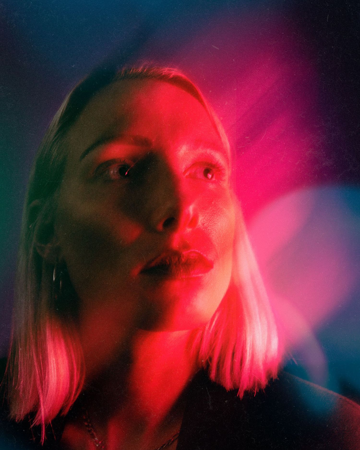 Moody portrait series with neon pink lighting creating ethereal atmospheric effect.