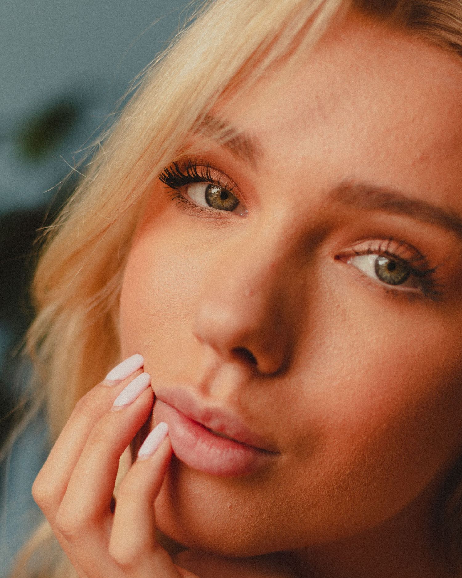 Close-up beauty shots highlighting natural makeup and contemplative poses.