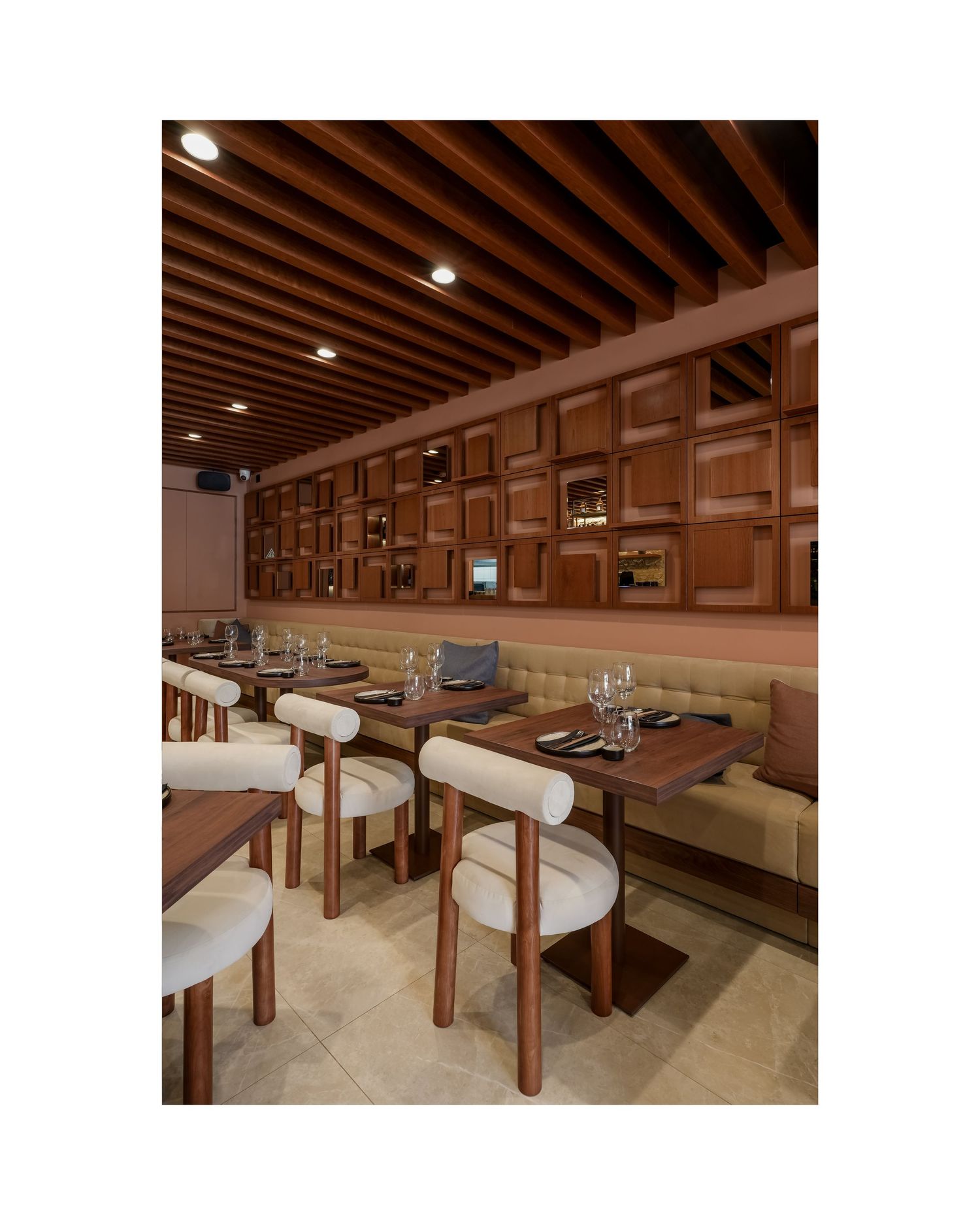 Rustic dining space with wooden ceiling beams and built-in booth seating.