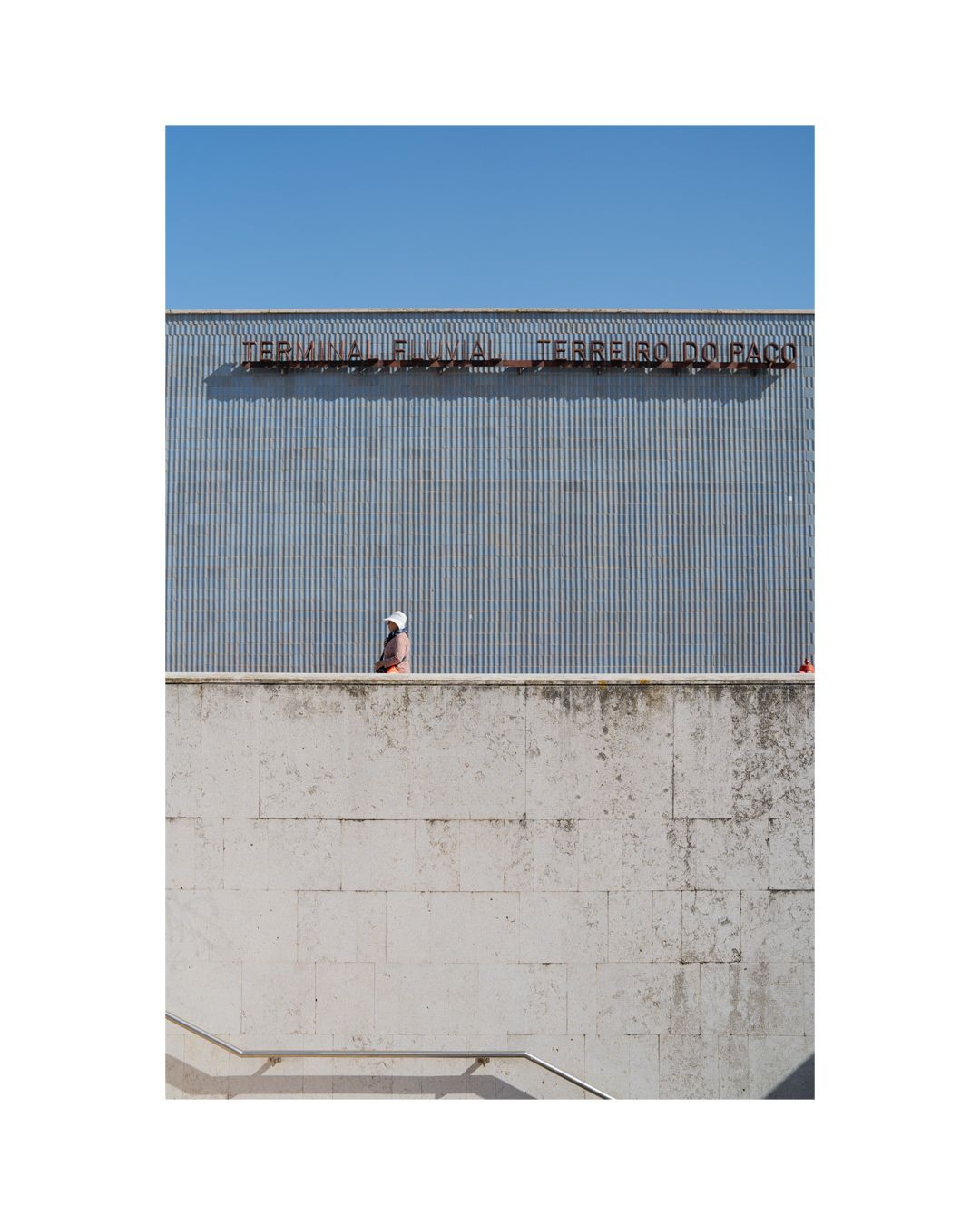 Industrial building exterior with text signage and concrete walls.