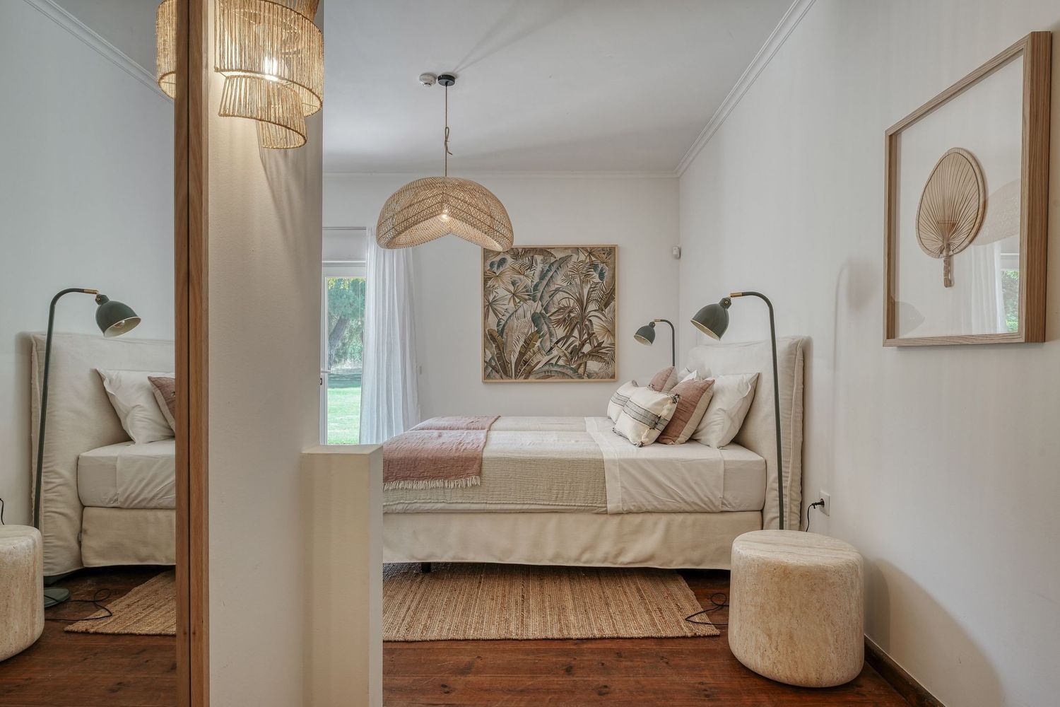 Bright Scandinavian-style bedroom with neutral tones, wooden floor, pendant light, and elegant wall art.