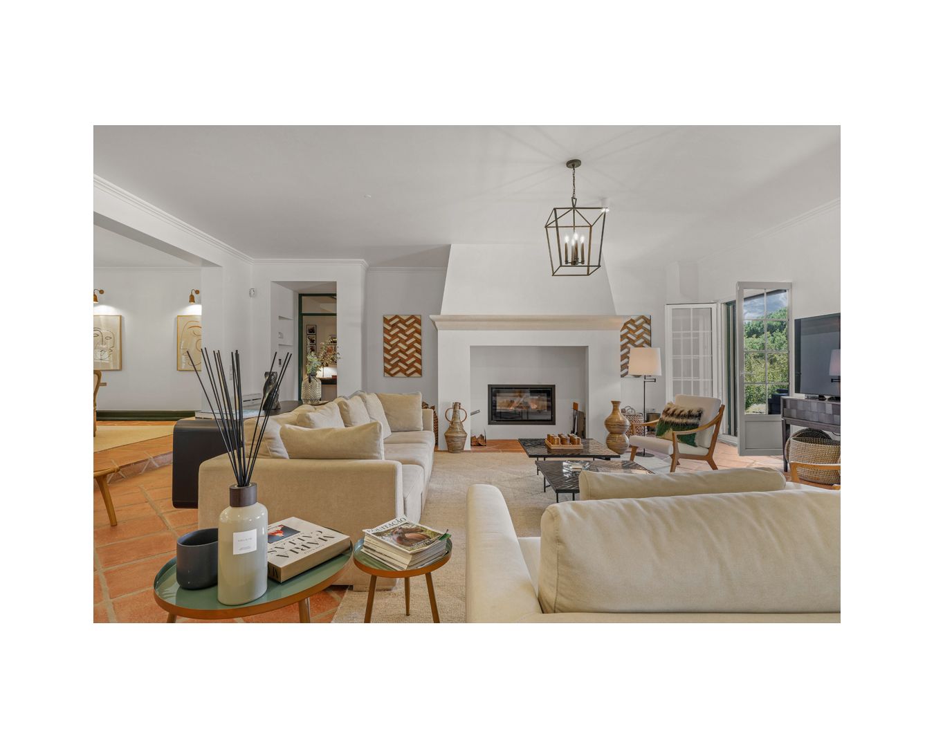 Spacious living room with comfortable beige seating and contemporary lighting fixtures.