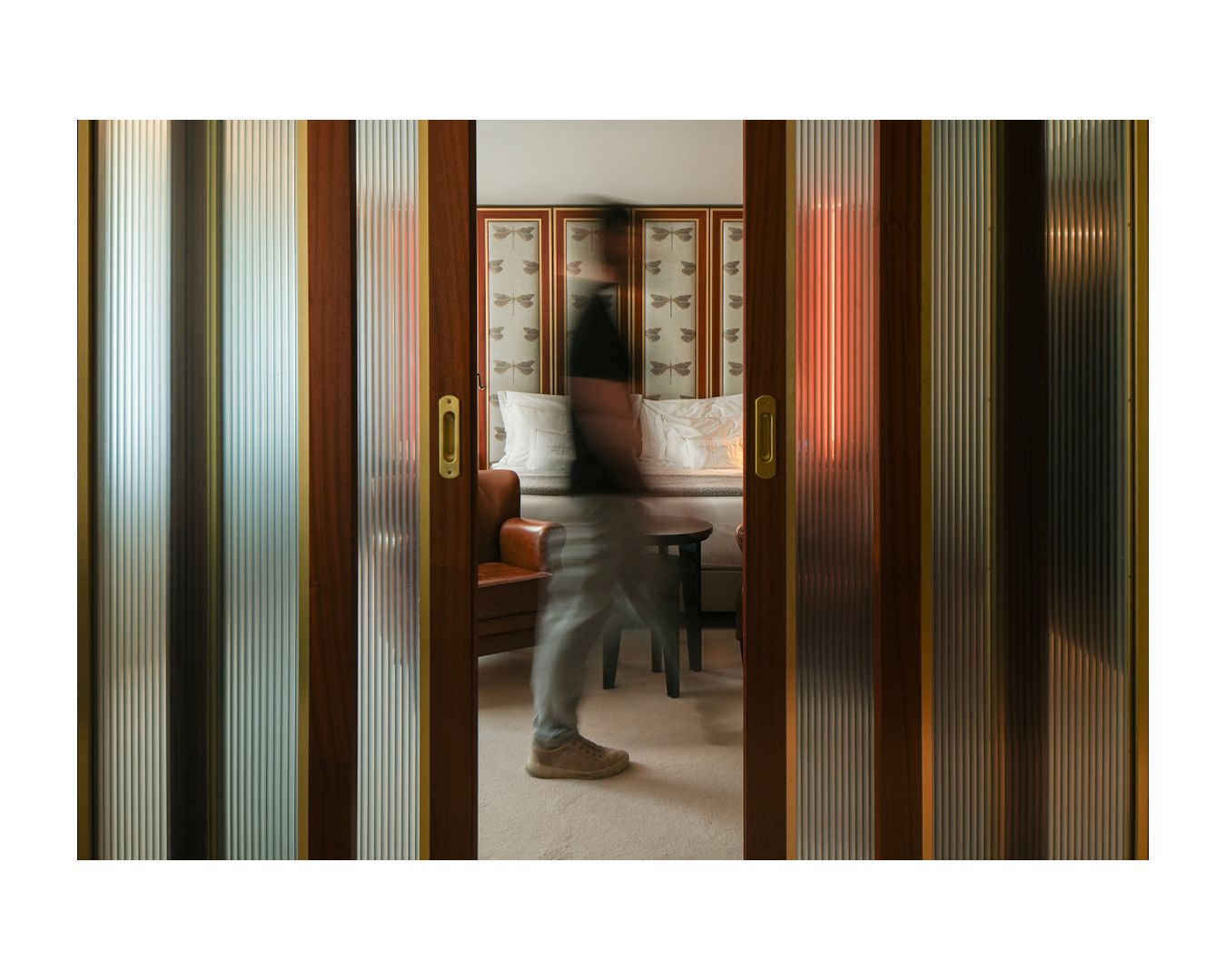 View through vertical wooden slats into an interior room space.