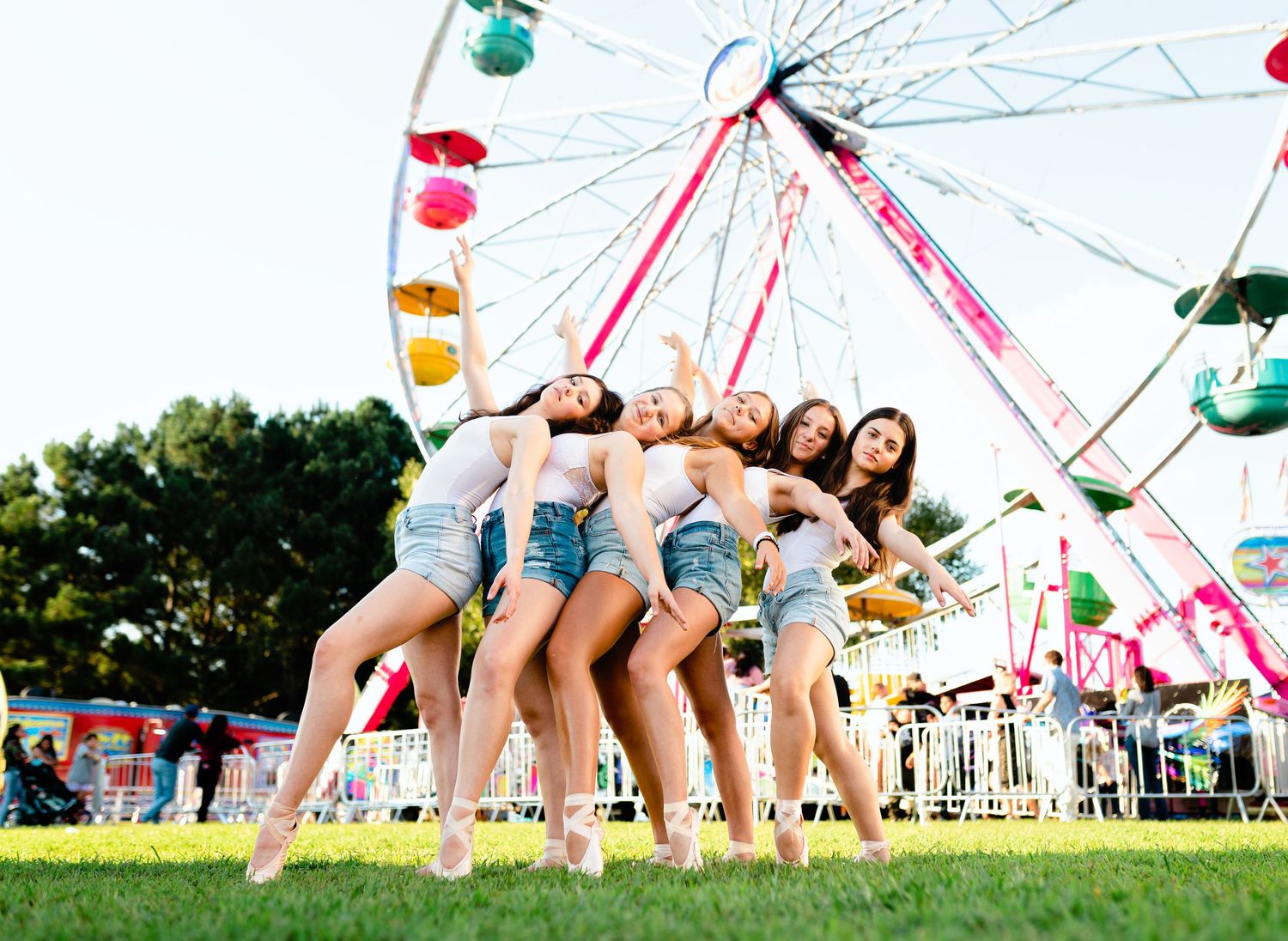 Aerial view of swings on carnival ride against bright summer sky.