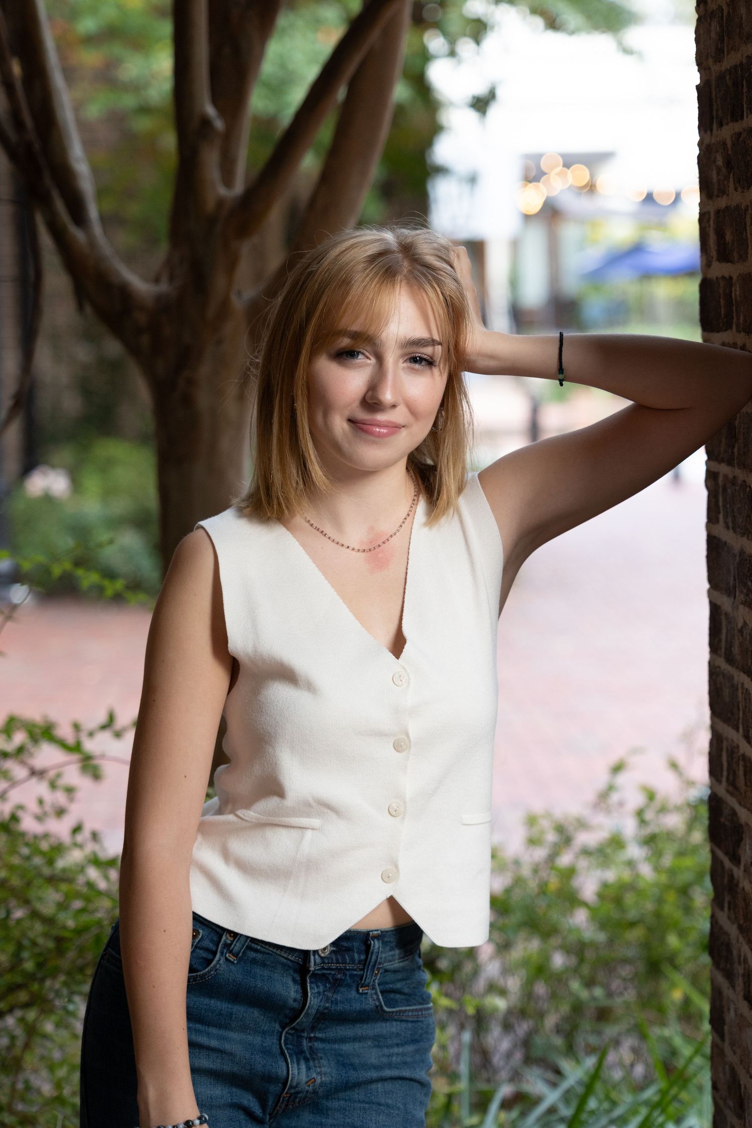 Natural lifestyle portraits showing gentle expressions in a garden setting.