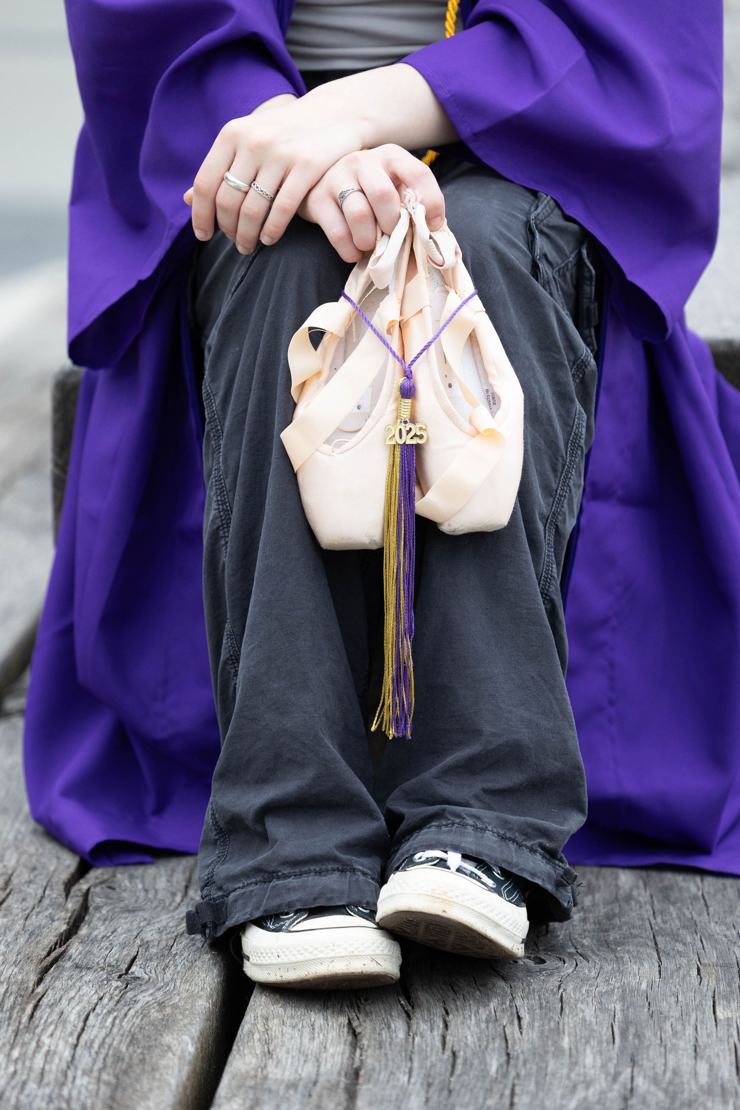 Graduation ceremony detail showing purple robes and black pants with hands holding a tassel in multiple sequential shots.