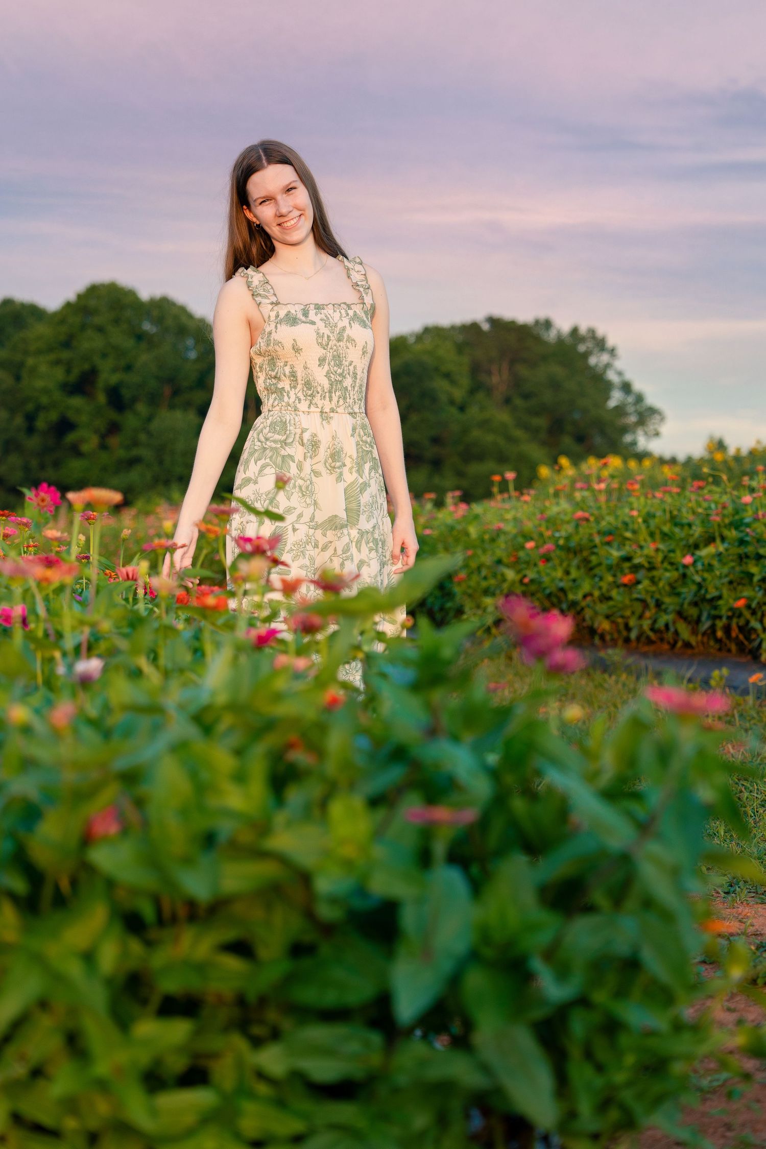 A floral sundress stands out among vibrant wildflowers and greenery in a summer garden at sunset.