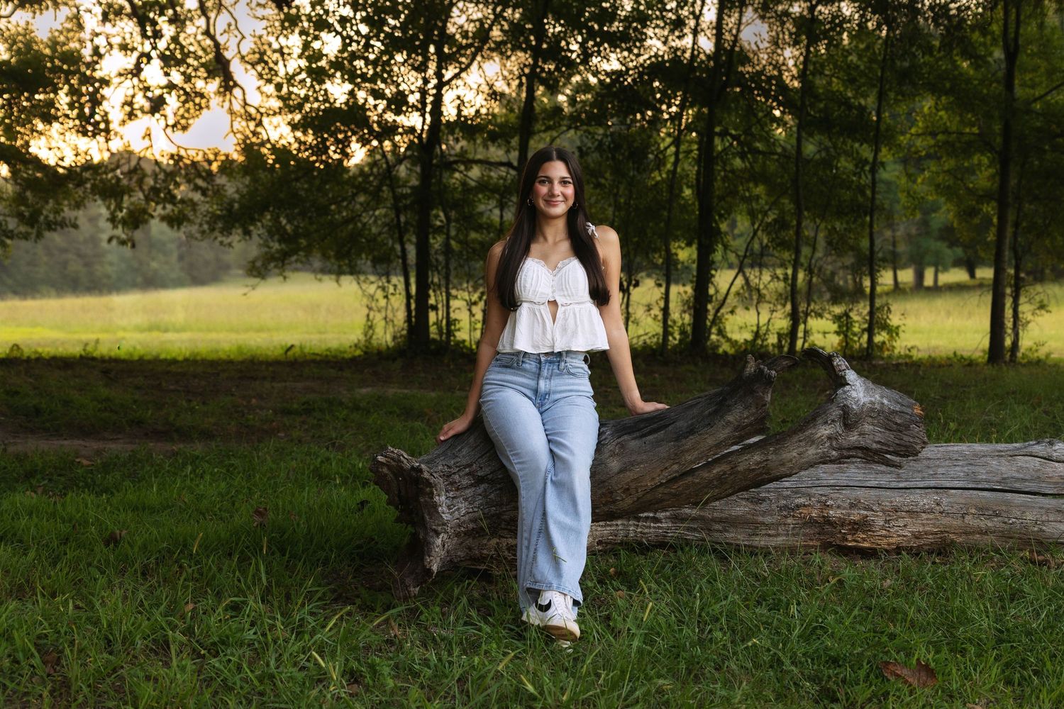 Artistic portrait series taken at sunset near fallen logs and trees.