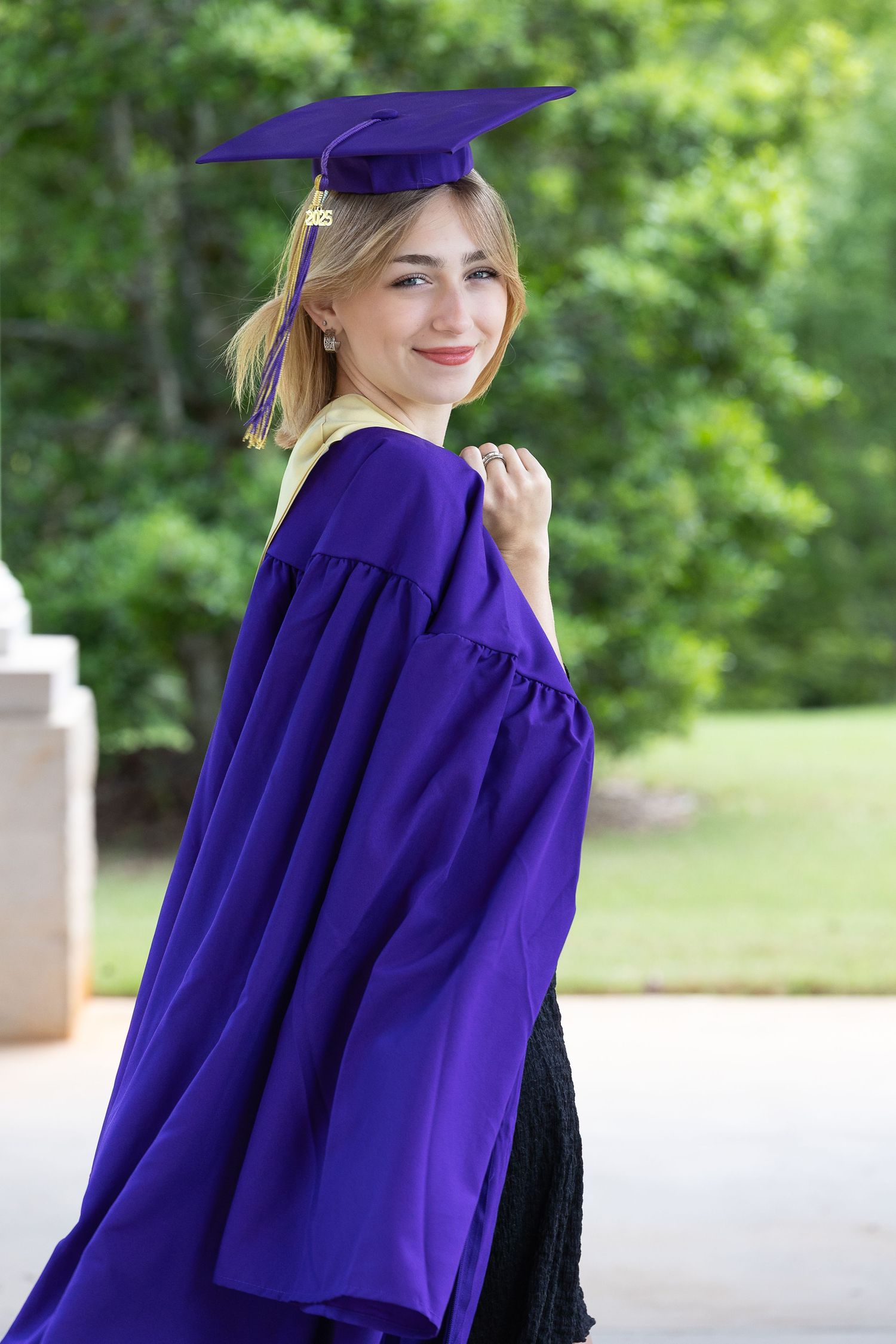 Graduation photos featuring purple cap and gown against outdoor setting.