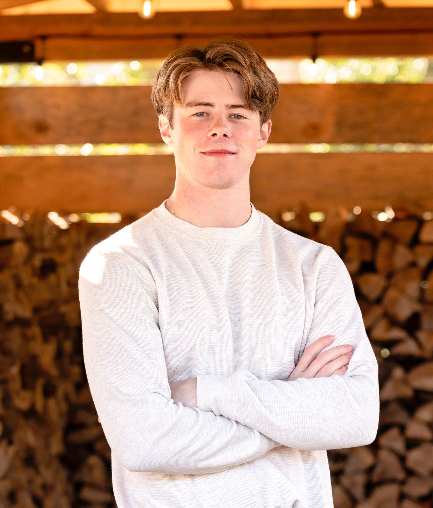 Person in white sweater shown in various poses against wooden background.