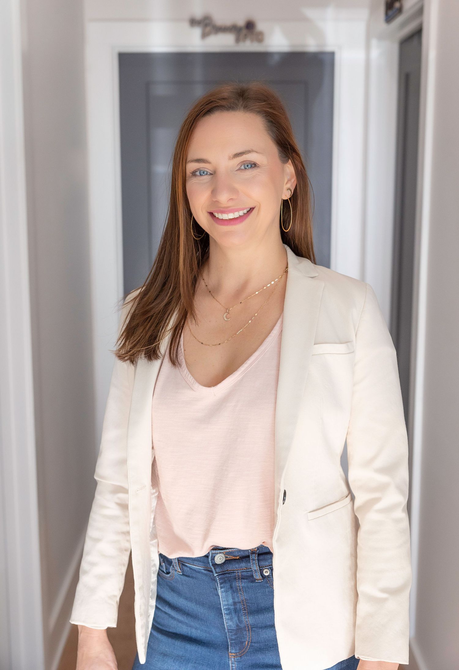 Professional fashion portrait series showing a white blazer and jeans outfit against a gray backdrop.