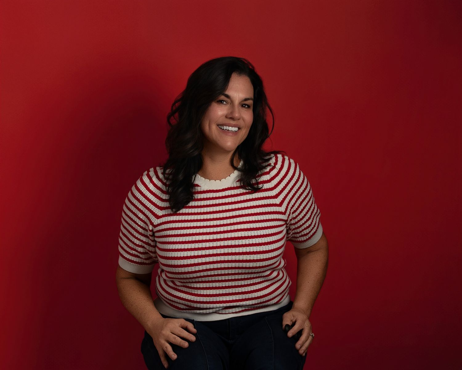 Woman in red and white striped top poses against burgundy background in a series of lifestyle shots.
