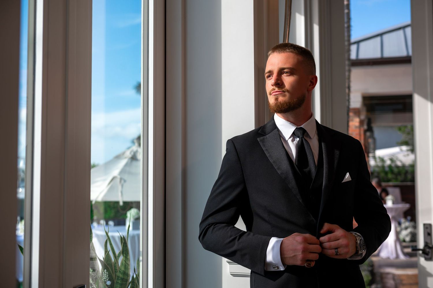 Wedding photographers in Florida captured this groom near the back deck at a Florida mansion in Pompano Beach.