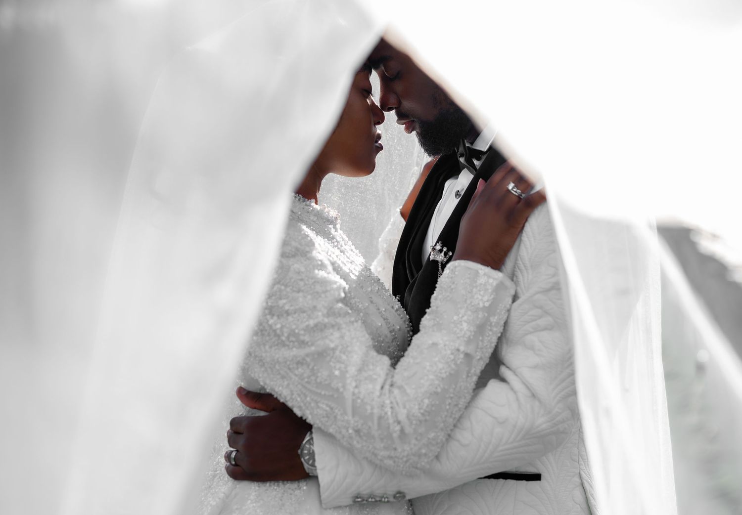 Luxury wedding photographers captured the bride and groom having a moment beneath her veil.