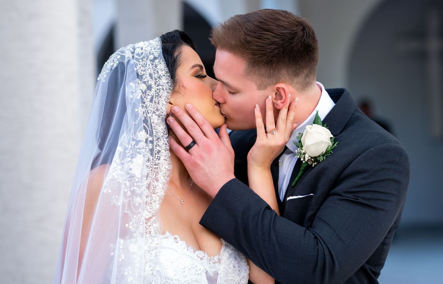 A romantic kiss between a groom and his new wife during their portrait session was captured by South Florida luxury wedding photographers.