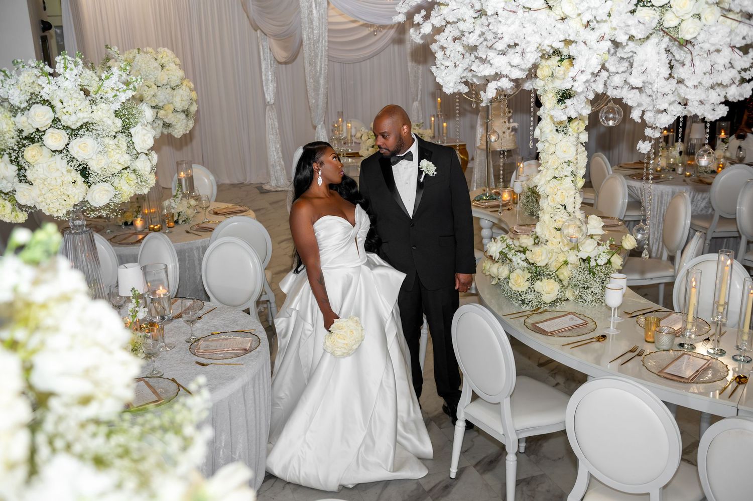 Florida luxury wedding photographers capture the bride and groom in their beautiful, floral-designed reception venue in Atlanta, Georgia.