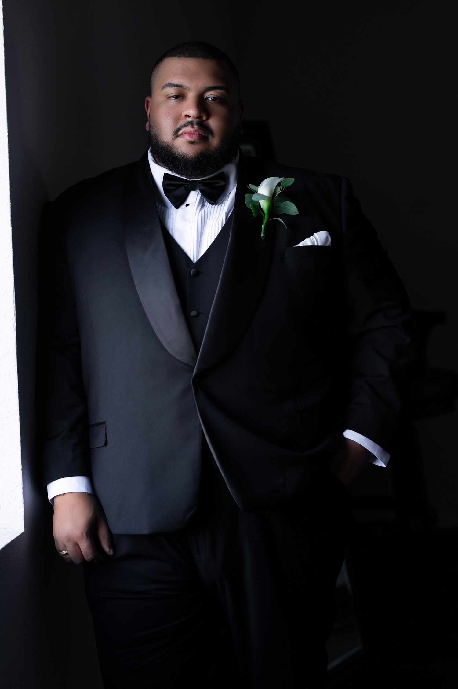 Soft window light touches the groom as he poses at Scars Farm. Photographed by Treasure Coast Wedding photographers.