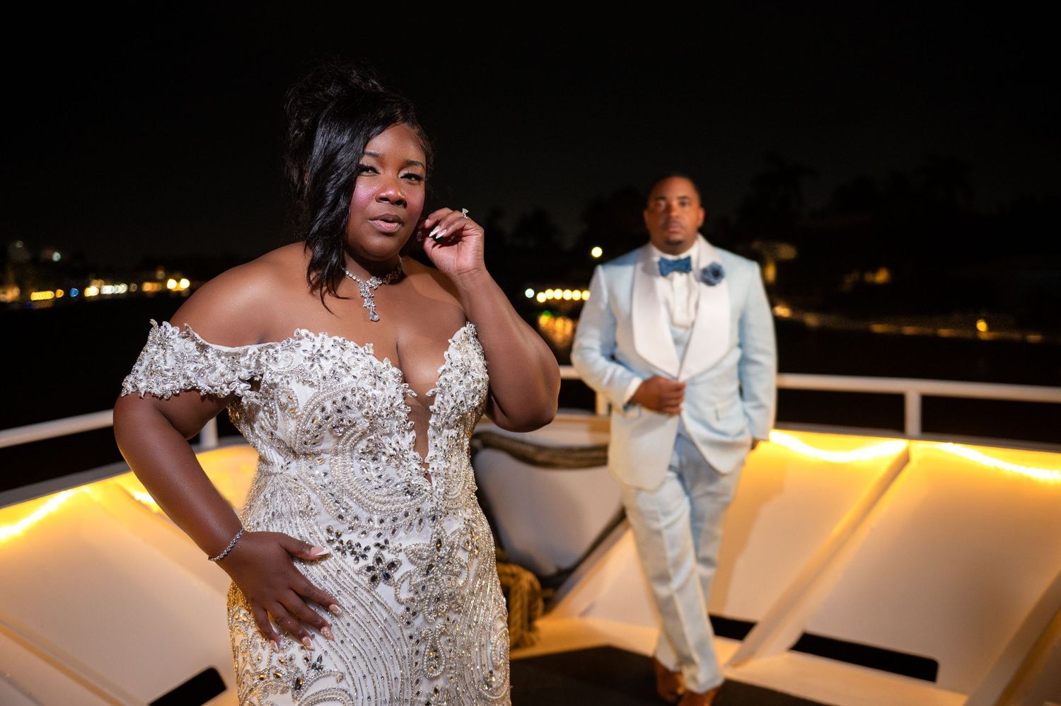 The bride and groom pose on the deck of the yacht, captured by Palm Beach wedding photographers.