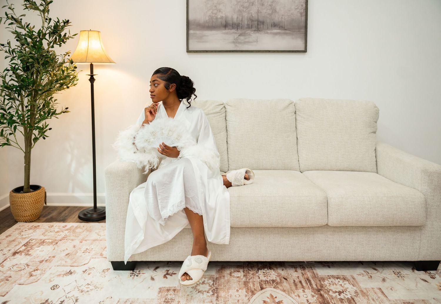 This bride reflects while sitting on her couch hours before her wedding. Palm Beach wedding photographers were there for this moment.