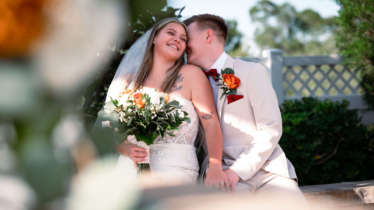The bride and groom laugh together as Treasure Coast wedding photographers direct the posing during their South Florida wedding photography.
