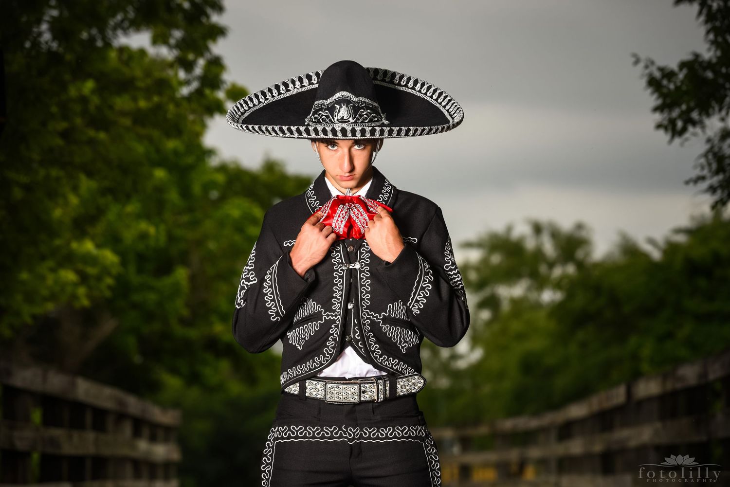 Stockyards inspired quinceañero photoshoot featuring young man celebrating quinceañero milestone with western theme