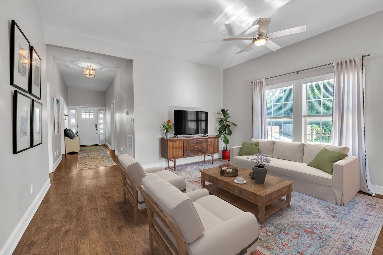 Modern living room with comfortable seating, wooden coffee table, and oriental rug.