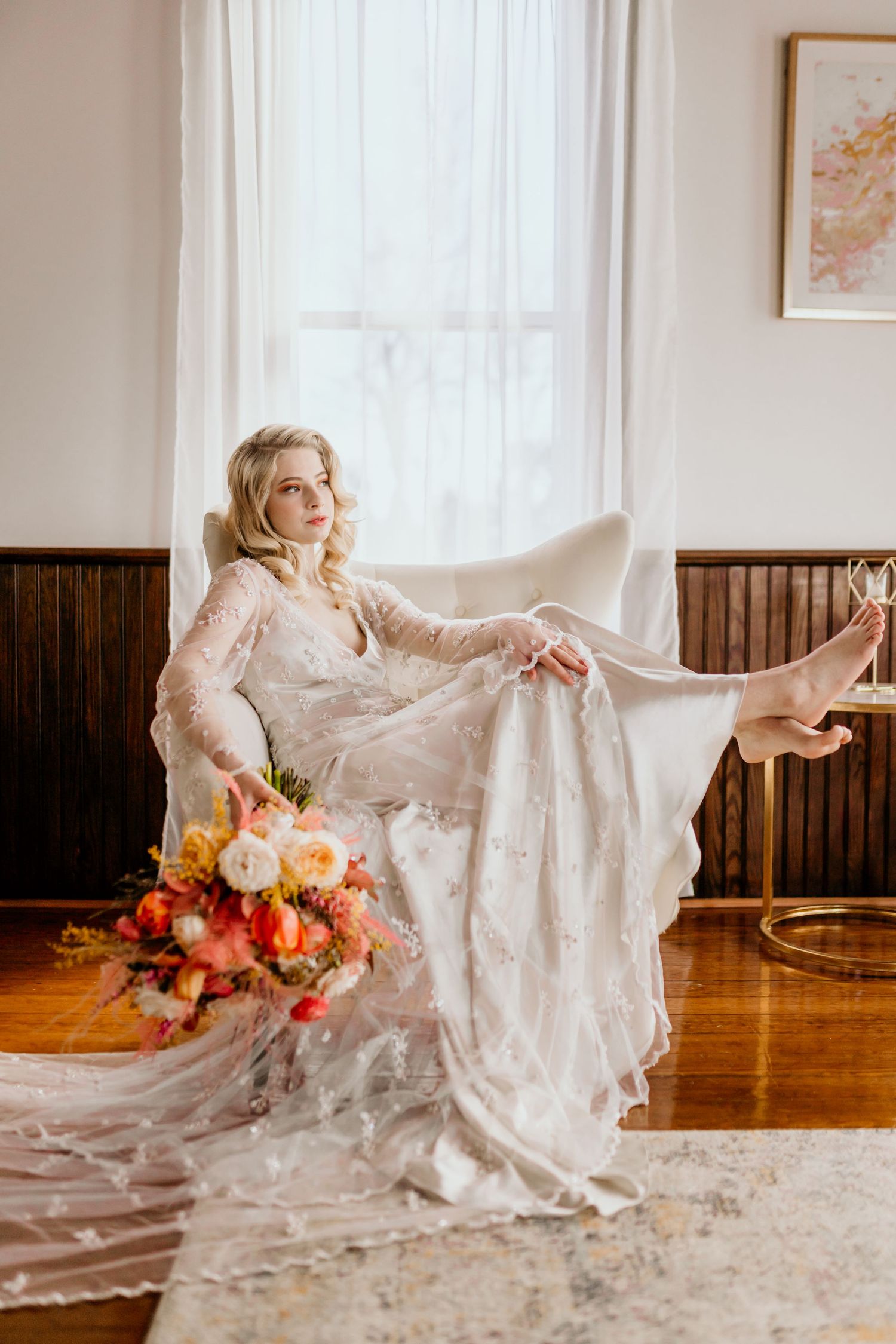 Bride relaxing in a chair holding her bouquet
