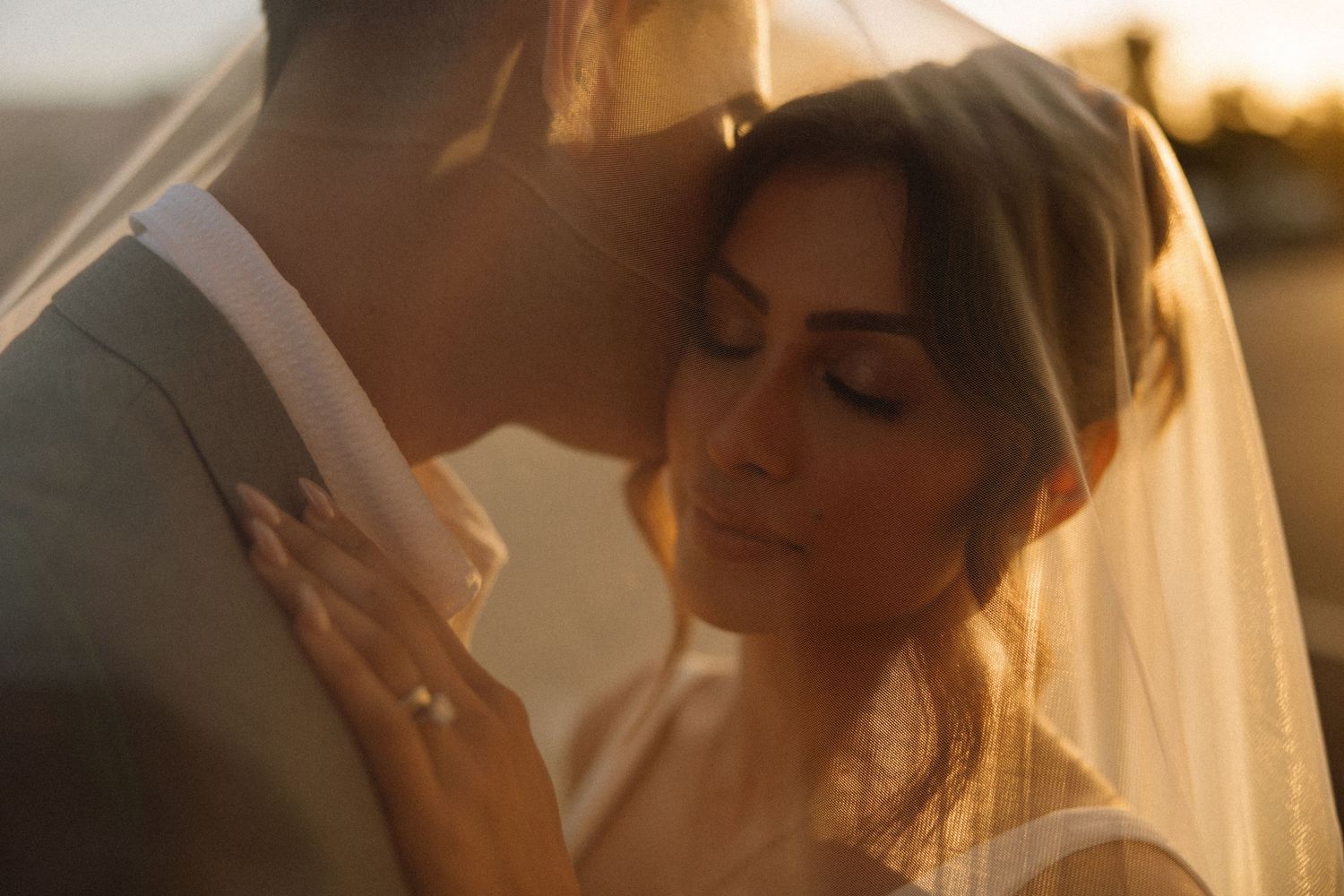 sunset bride and groom under the veil portrait at their San Diego sunset cliffs elopement captured by SoCal photographer Jocelyn Ann