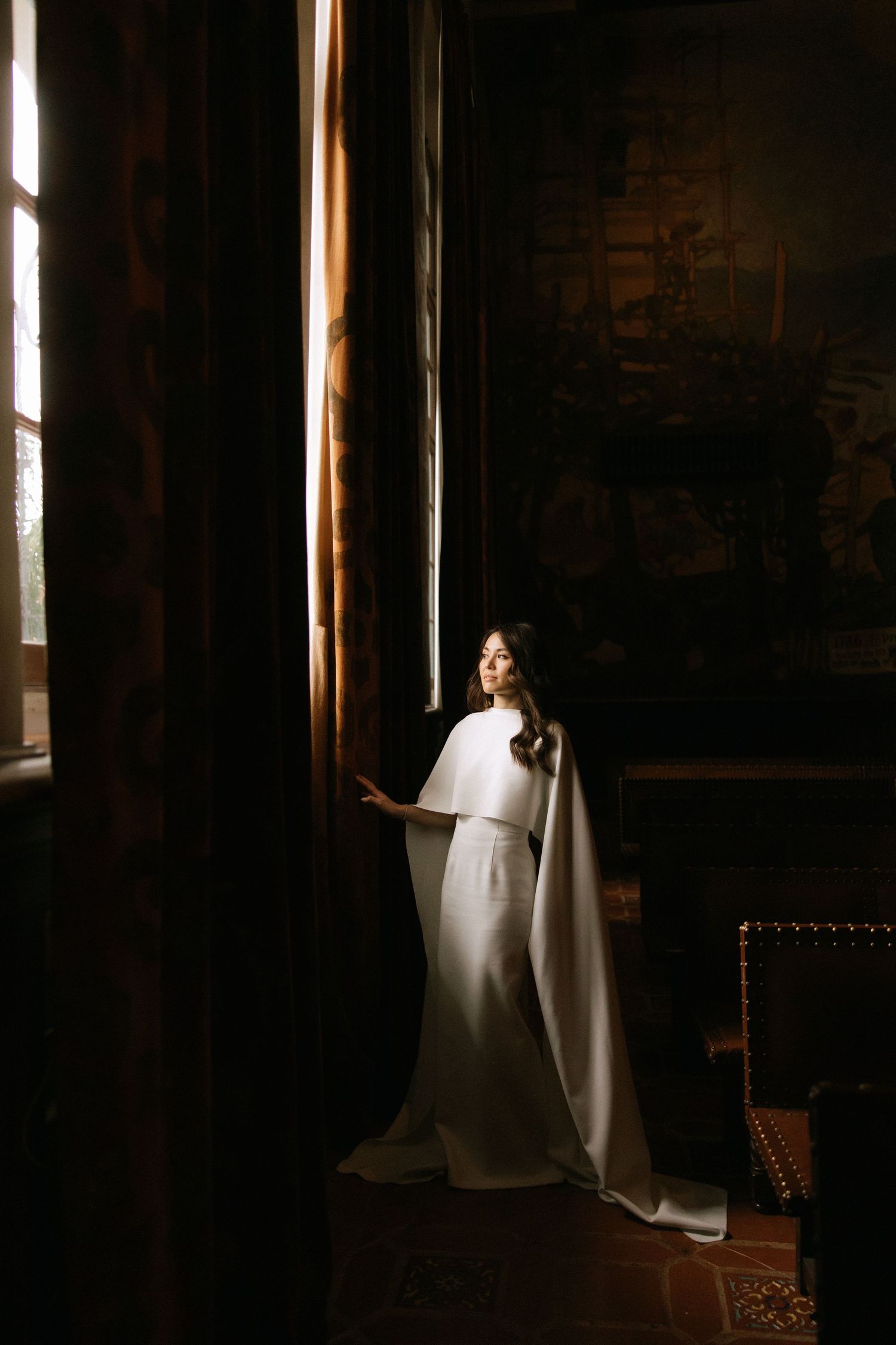 moody bridal portrait in the mural room of the santa barbara courthouse captured by southern california wedding photographer Jocelyn Ann