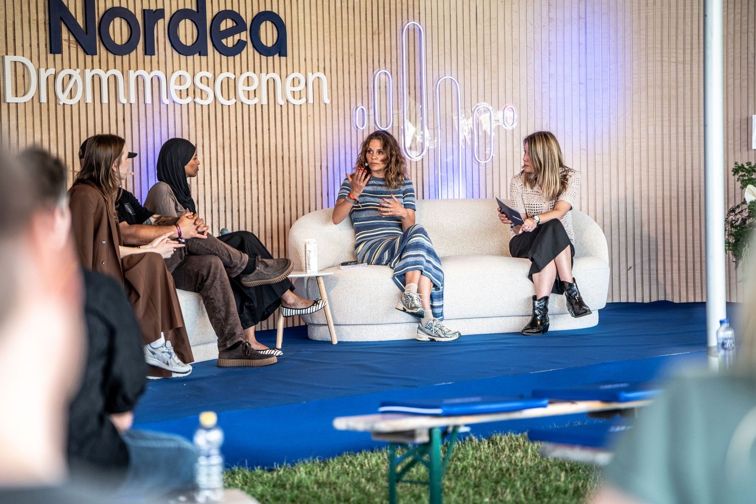Four women participating in a panel discussion at the Nordea Drømmescenen outdoor stage event.