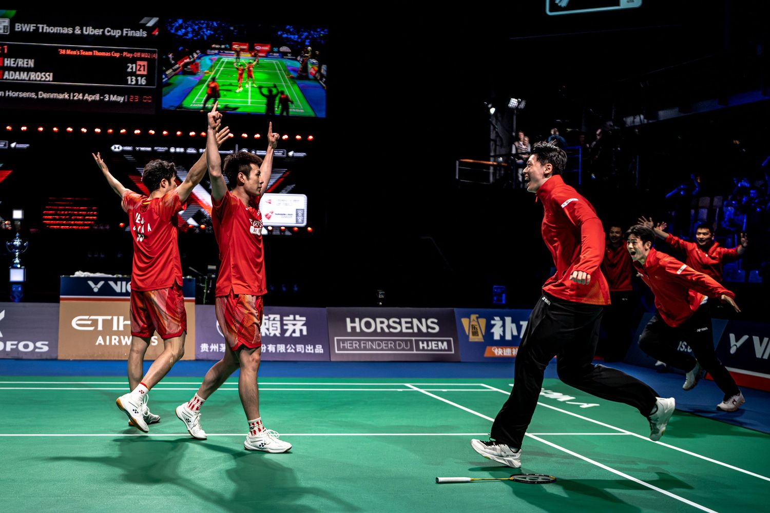 Chinese badminton team celebrating victory on court at BWF Thomas and Uber Cup Finals in Horsens Denmark.