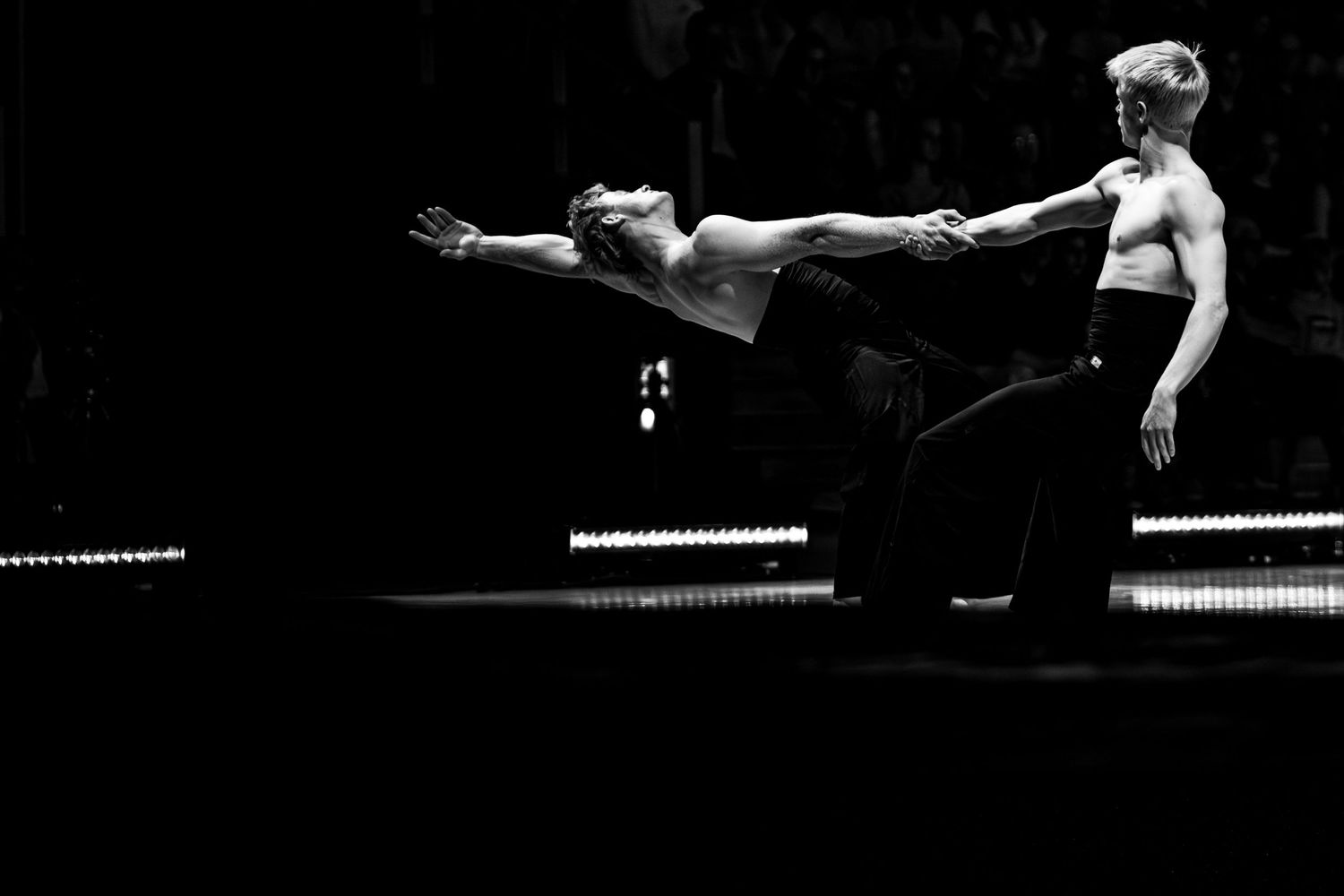 Black and white photo of two dancers performing an expressive partnered contemporary dance.