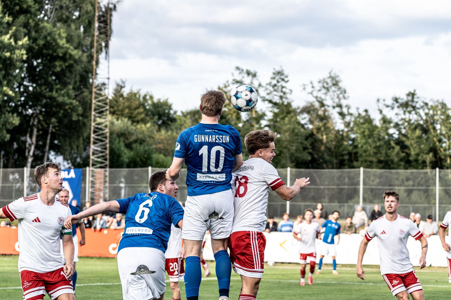 Soccer player number 10 Gunnarsson heading the ball during a competitive match.