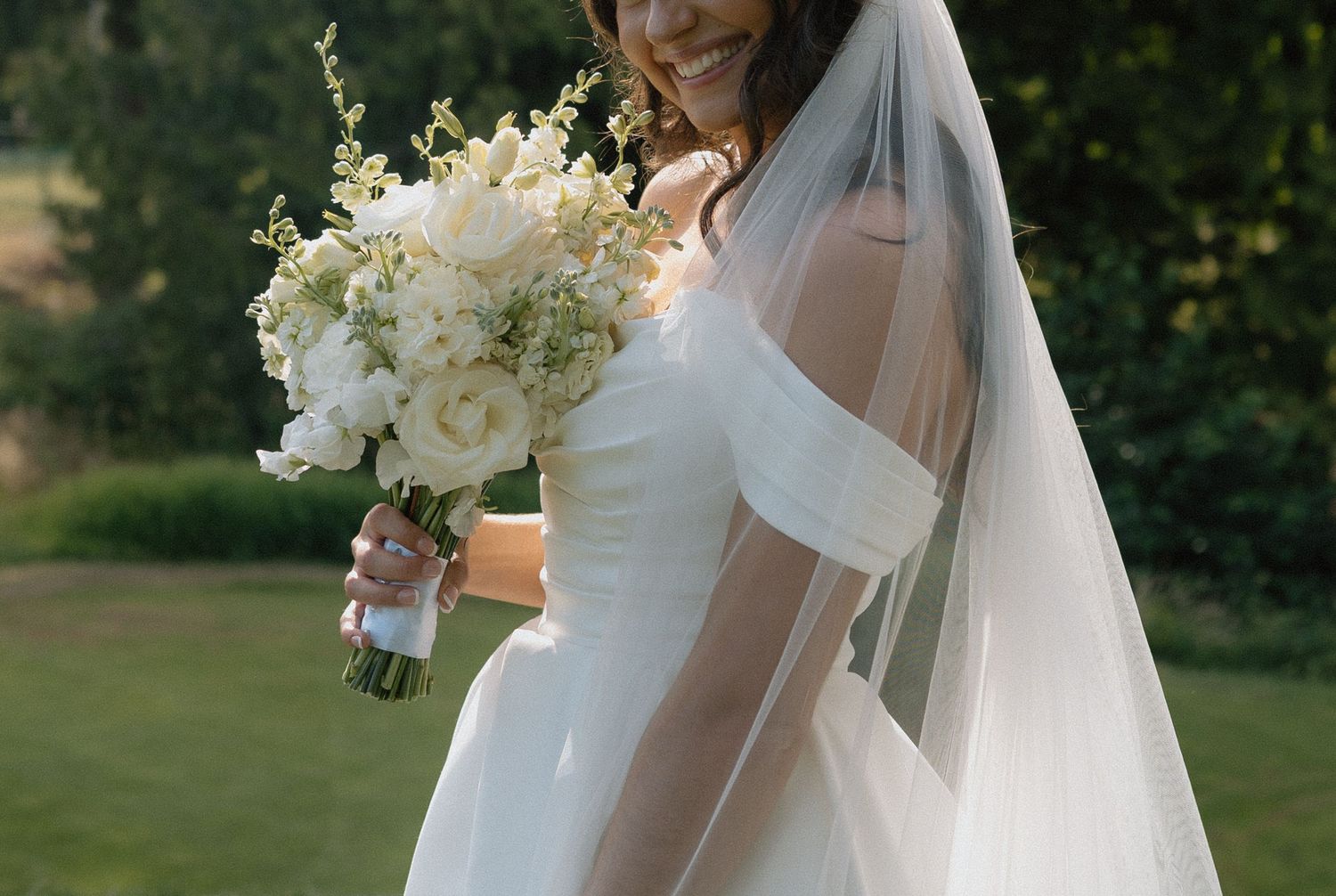close up of a bride in her veil and bouquet