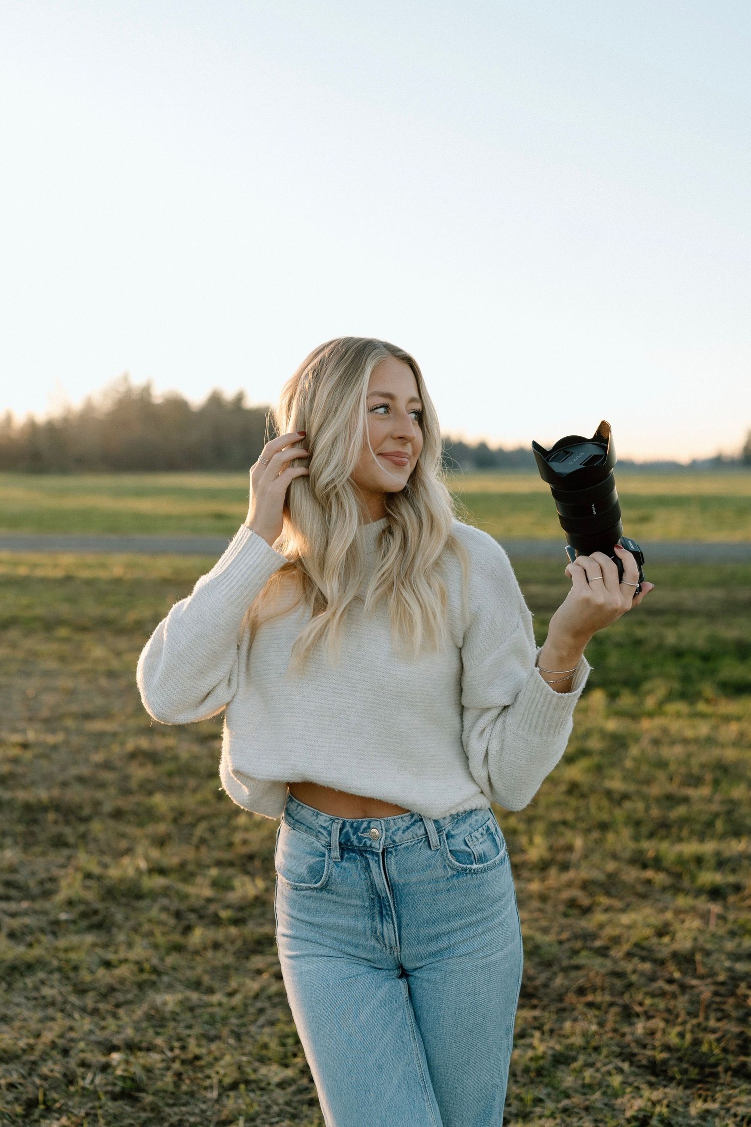a photographer holding her camera looking to the side