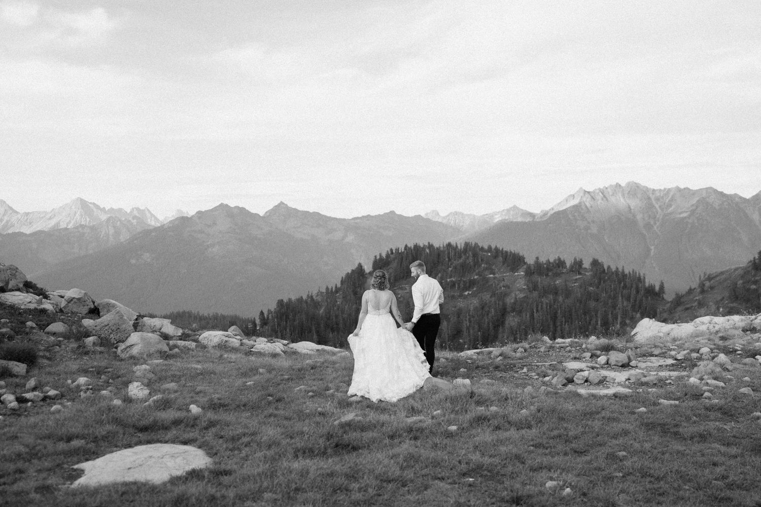 bride and groom holding hands walking away