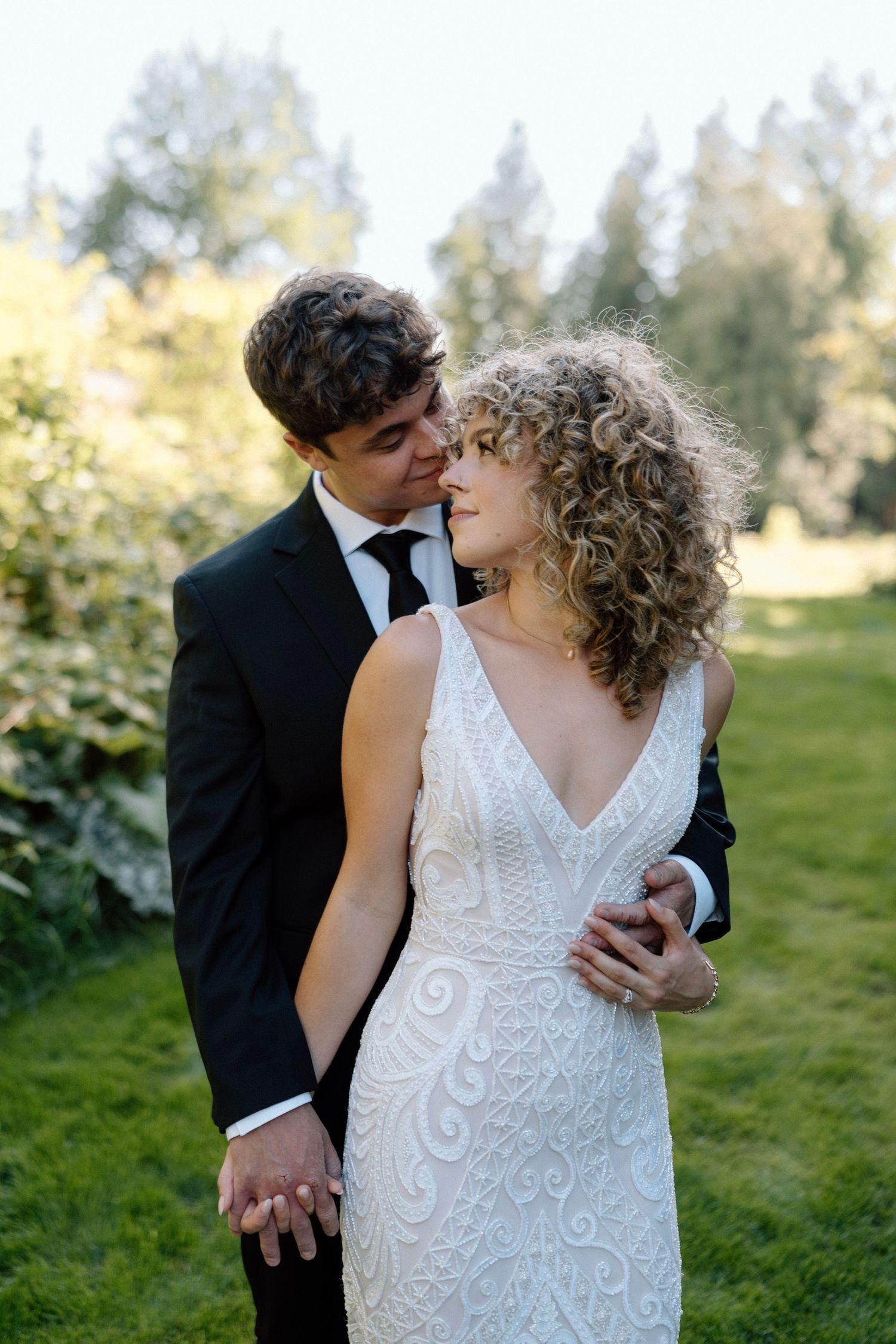 a bride and groom look at each other