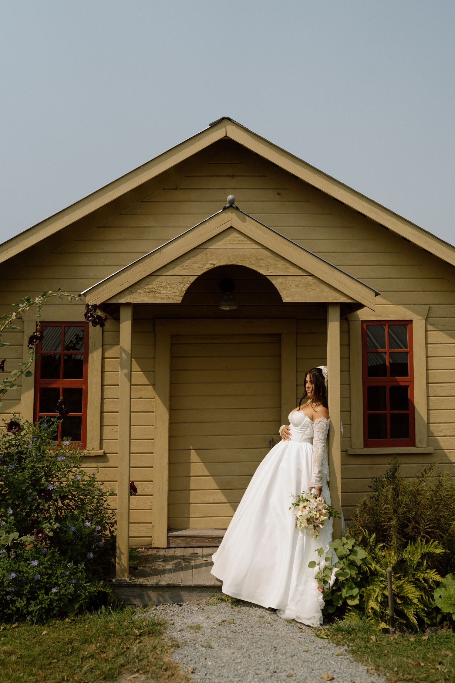 a bride leaning against a post